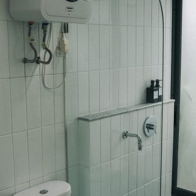 a white toilet sitting next to a walk in shower